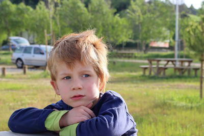 The blond boy looks to the side with interest. thoughtful five-year-old boy.