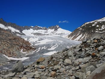 Scenic view of snowcapped mountain against blue sky