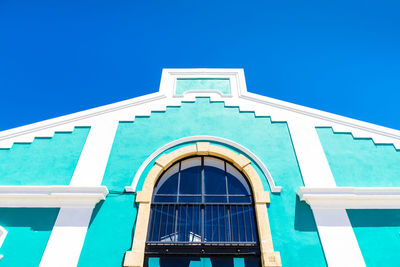 Low angle view of building against clear blue sky