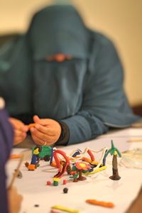 Front view of person working with clay models