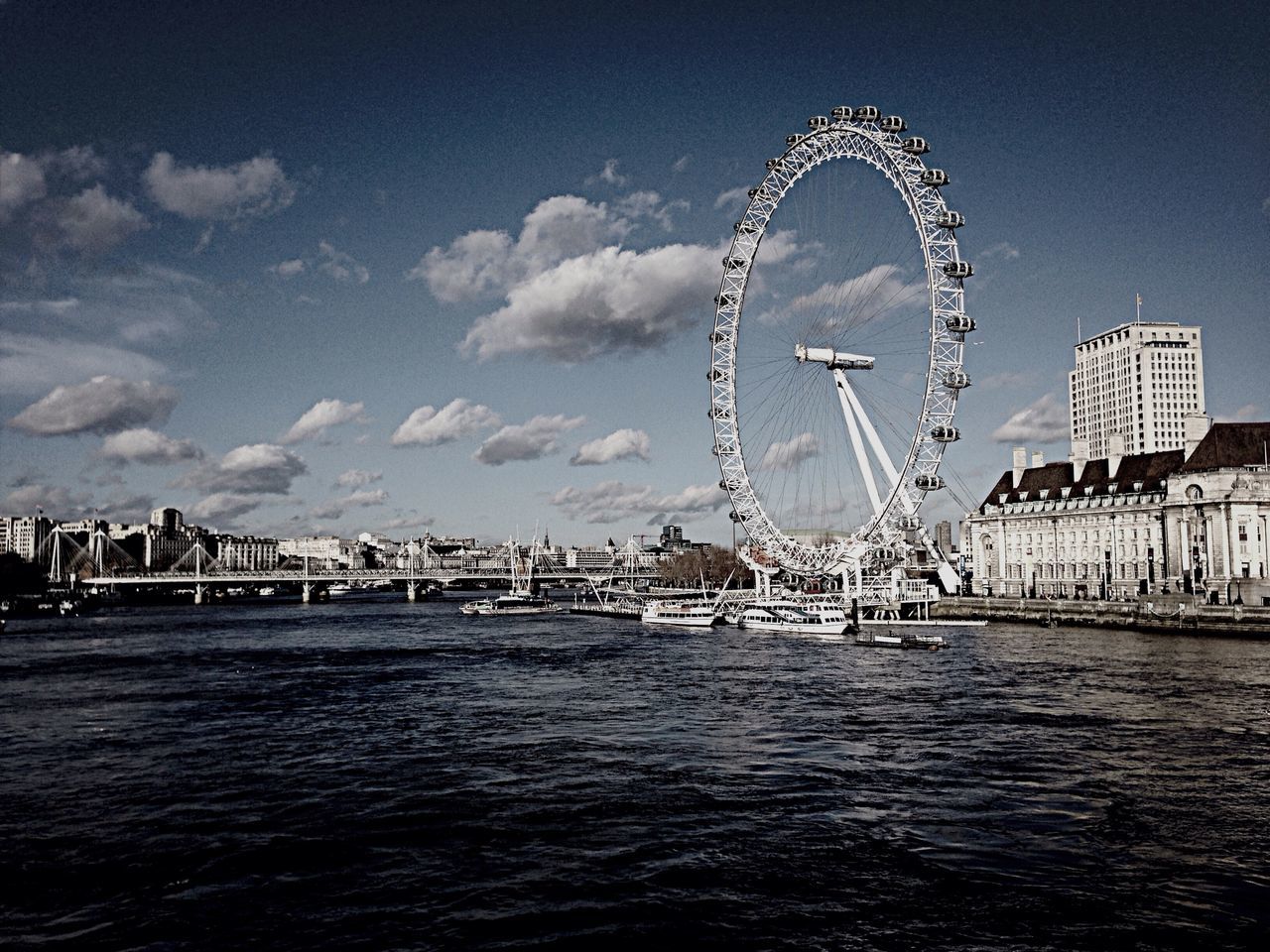 ferris wheel, built structure, architecture, amusement park ride, amusement park, water, sky, arts culture and entertainment, waterfront, building exterior, travel destinations, city, famous place, tourism, international landmark, capital cities, travel, tall - high, river, low angle view