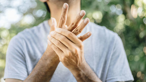 Midsection of man with arms raised