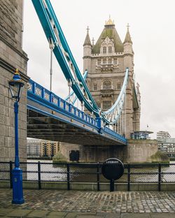 Low angle view of tower bridge against sky in city