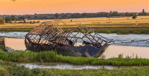 Scenic view of lake against sky during sunset