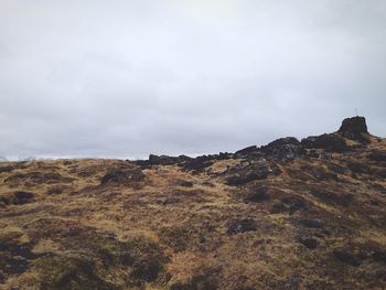 Scenic view of landscape against cloudy sky