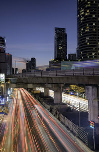 Light trails on road in city at night