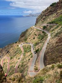 August 5th 2021. winding road with hairpin bends leading to praia de garajau, santa cruz, madeira