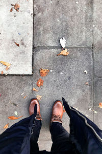 Low section of man standing on footpath