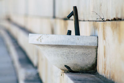 Close-up of metal railing against wall