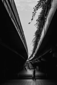 People walking on bridge in city