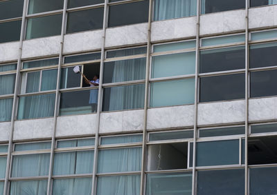 Low angle view of man working on building