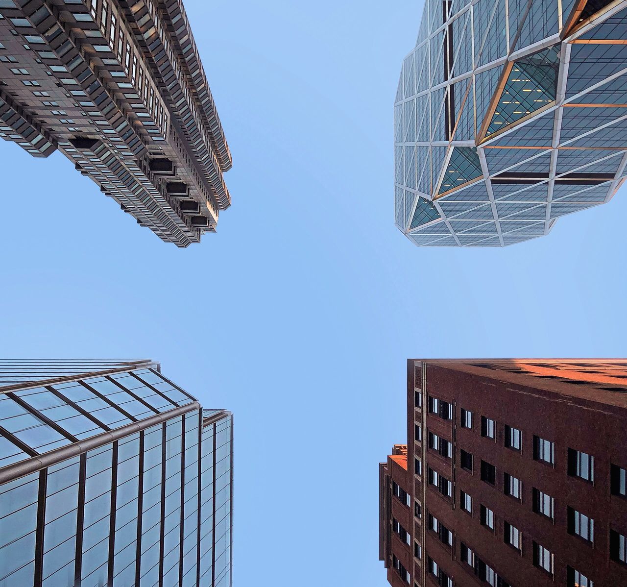 LOW ANGLE VIEW OF MODERN BUILDINGS AGAINST BLUE SKY