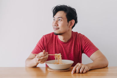 Portrait of young man eating food