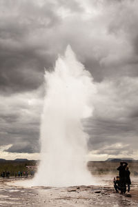Panoramic shot of man standing by sea against sky