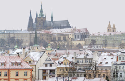 Buildings in town against clear sky