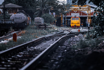 Train on railroad tracks against trees