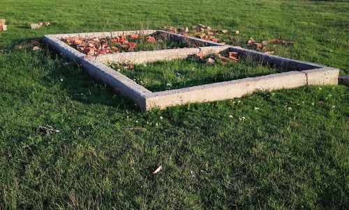 High angle view of bench on field in park