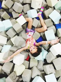 Directly above shot of girl lying while playing with sponges