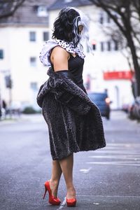 Full length of fashionable woman standing on road