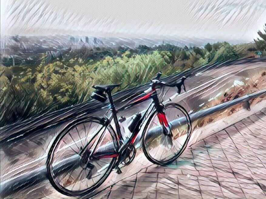 BICYCLE PARKED ON FOOTPATH AGAINST LANDSCAPE