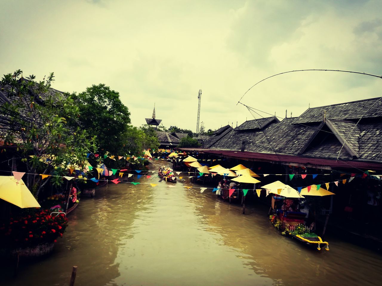 BOATS IN CANAL AGAINST SKY