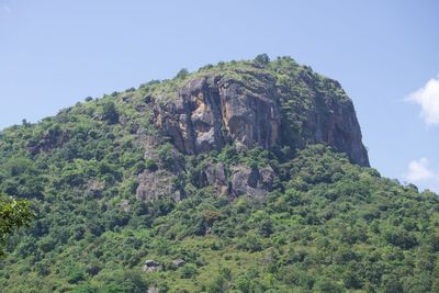 Low angle view of rocky mountain against sky