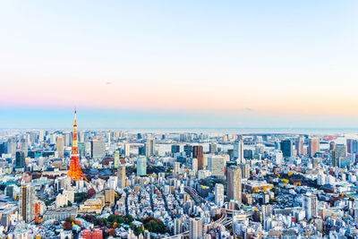 High angle view of city buildings against sky during sunset