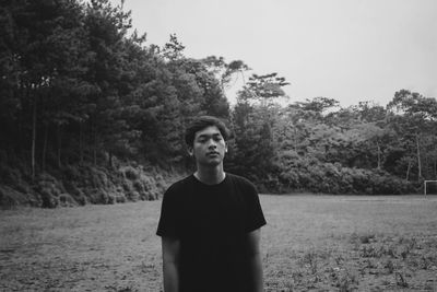 Portrait of young man standing on land