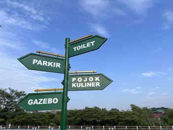 Green road sign in the park for giving direction and information to people where to go.