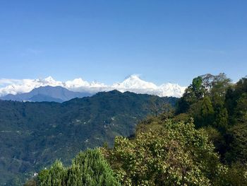 Scenic view of mountains against blue sky