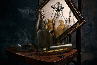 Old bottle on table against dark background