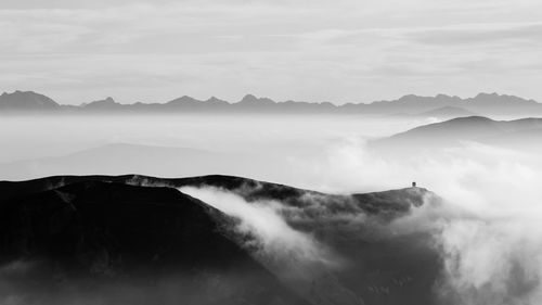 Scenic view of silhouette mountains against sky