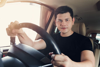 Portrait of man sitting in car