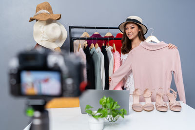 Portrait of smiling young woman standing in store