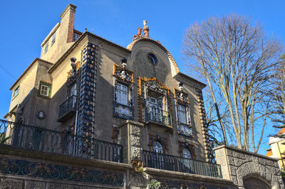 Low angle view of historic building against sky, window tile decoration on facade at usa embassy 