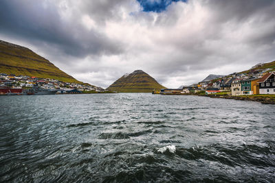 Panoramic view of sea and buildings against sky