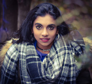 High angle portrait of smiling young woman outdoors