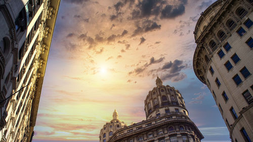 Low angle view of buildings against sky during sunset