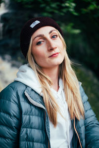 Portrait of young woman standing outdoors