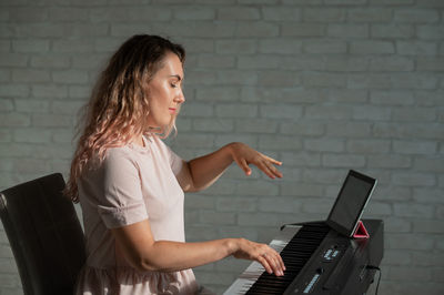 Young woman using laptop at home