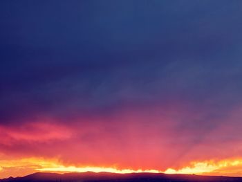 Low angle view of dramatic sky during sunset