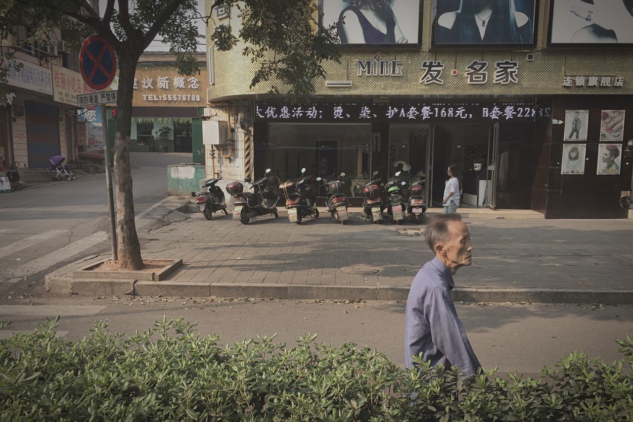 building exterior, architecture, built structure, lifestyles, men, casual clothing, person, leisure activity, walking, rear view, full length, standing, city, outdoors, religion, street, day