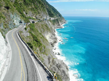 High angle view of road by sea against sky