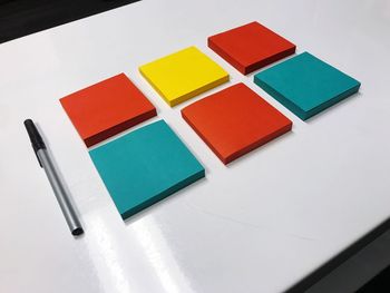 High angle view of multi colored adhesive notes on table