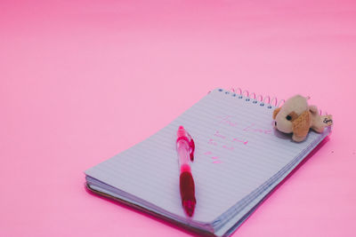 Close-up of stuffed toy against pink background
