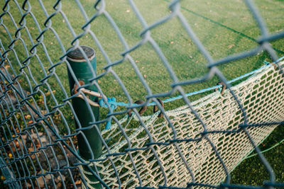 High angle view of chainlink fence on grass