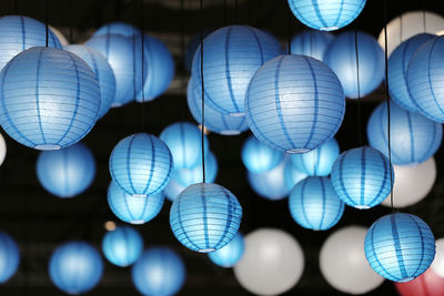 Low angle view of illuminated lanterns hanging at night