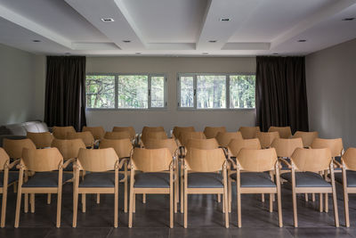 Empty chairs and tables in room