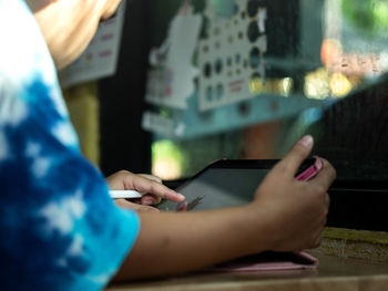 Midsection of woman using mobile phone