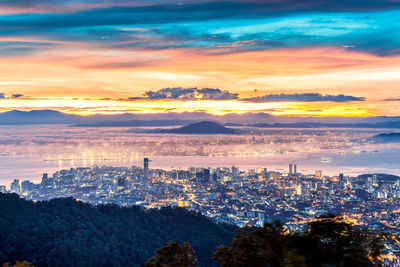 High angle view of buildings against sky during sunset